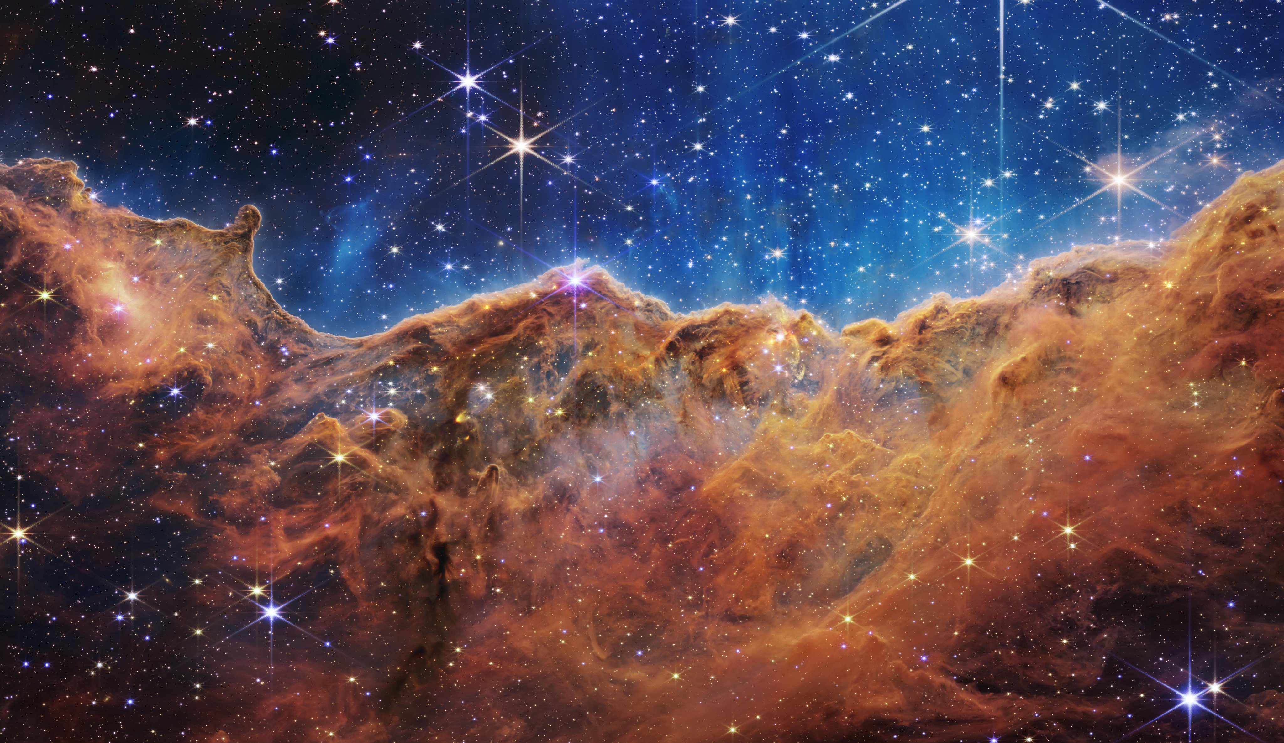 Behind the curtain of dust and gas in these “Cosmic Cliffs
