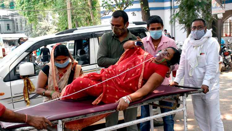 A COVID-19 patient arrives at a government hospital for admission, amid a rise in COVID-19 cases across the country, in Patna on Monday