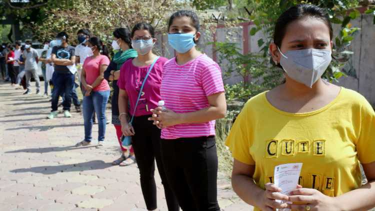 People over 18 years old wait in a queue to receive the COVID-19 vaccine dose, in Bhopal on Wednesday