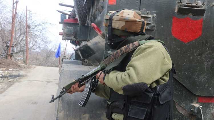 Security forces stand guard near encounter site at Rawalpora Shopian