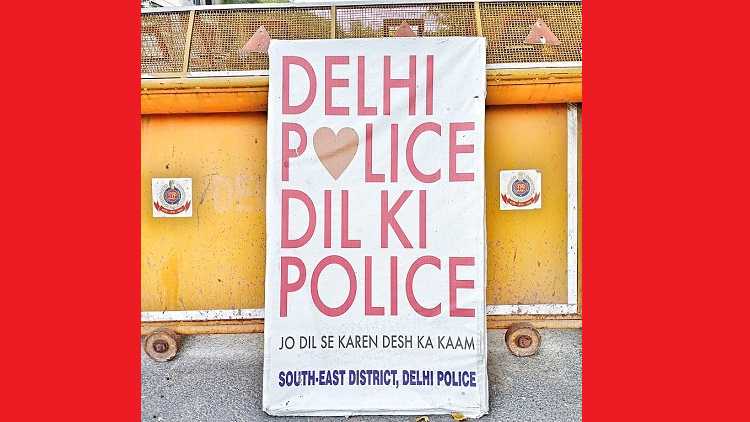 Delhi Police logos & slogan on a barricade