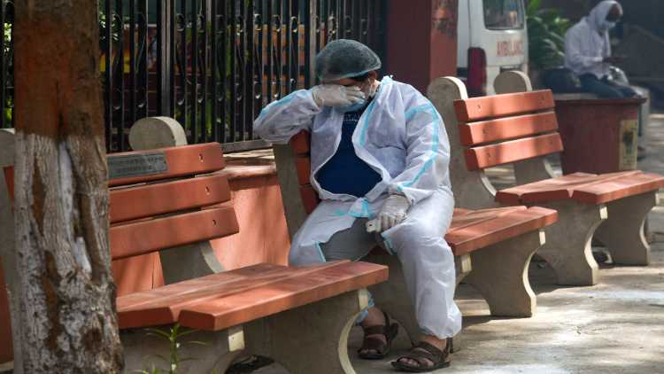 A relative got emotional during the last rites of a COVID victim, at Nigambodh cremation ground in New Delhi on Saturday