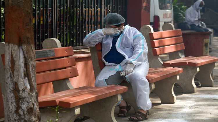 A relative got emotional during the last rites of a COVID victim, at Nigambodh cremation ground in New Delhi on Saturday