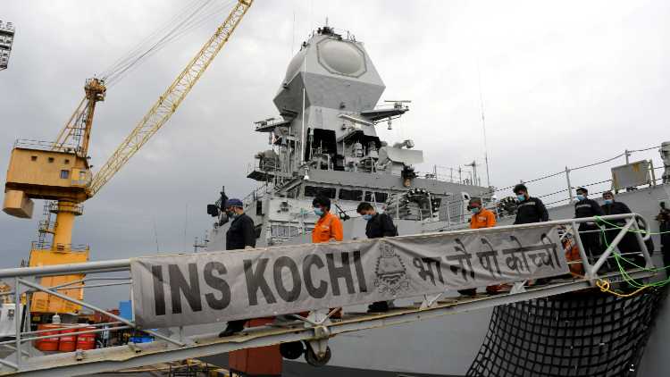 Crew rescued by Indian Navy from Barge P305 walks out of INS Kochi after arriving in Mumbai