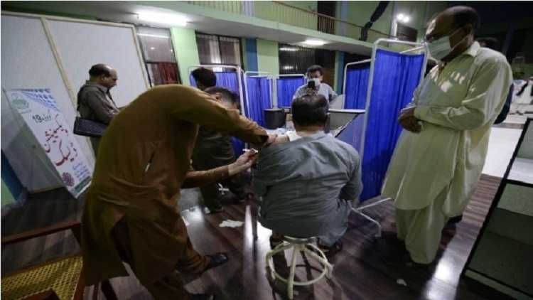 A man receives a dose of the COVID-19 vaccine at a vaccination center