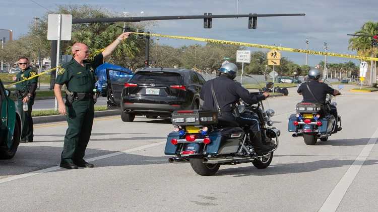 Police officers stand guard near Marjory Stoneman Douglas High School