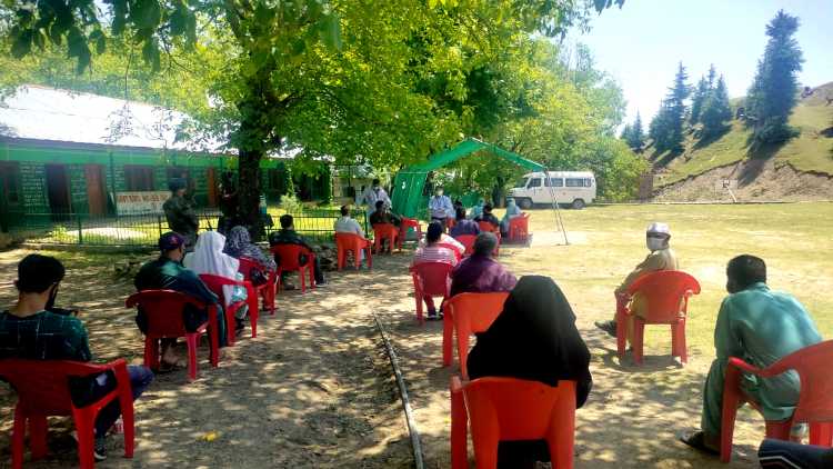Kashmiri villagers waiting during 15 Rashtriya Rifles (RR) army kukroosa-Handwara Army Camp for COVID vaccination