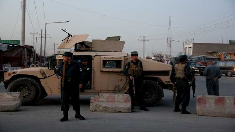 Afghan security force members stand guard near the site of an attack in Kabul