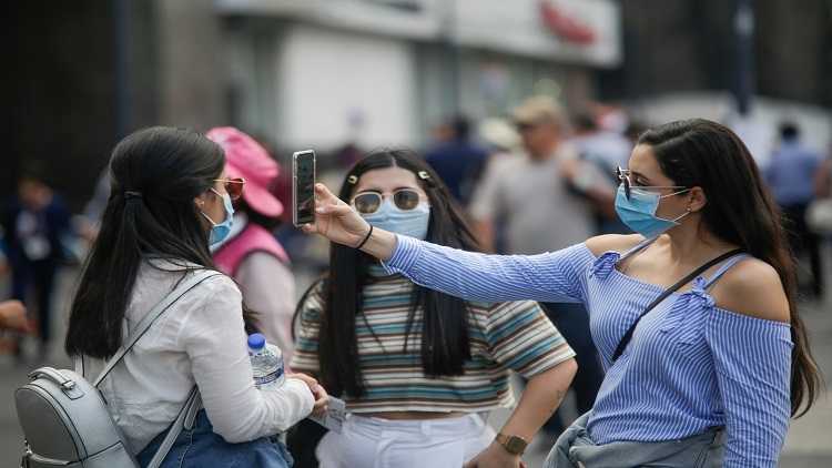 Pedestrians wearing face masks are seen in Mexico City