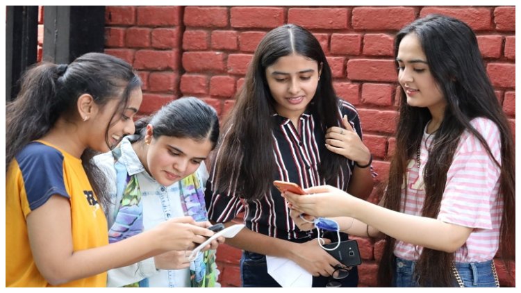 Students check their results on their smartphone