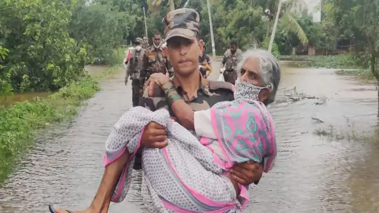 A woman being rescued from floods