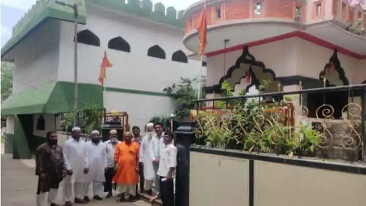 Villagers in front of the temple and mosque in Ghorpadi village