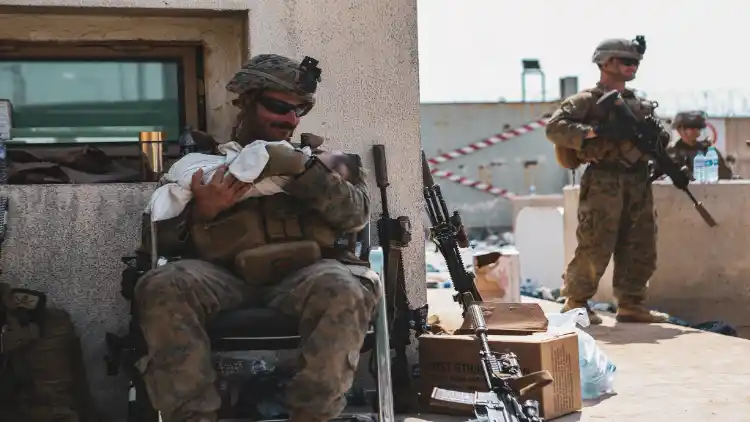 The Afghan baby being taken care of by a US Marine (Twitter)