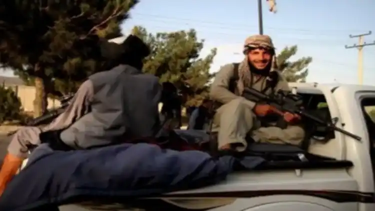 Taliban fighters riding a jeep in Kabul