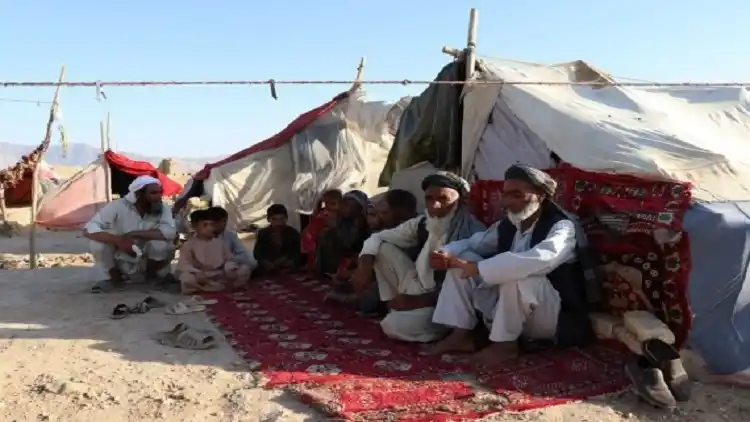 People are seen at a displaced person camp in Mazar-i-Sharif