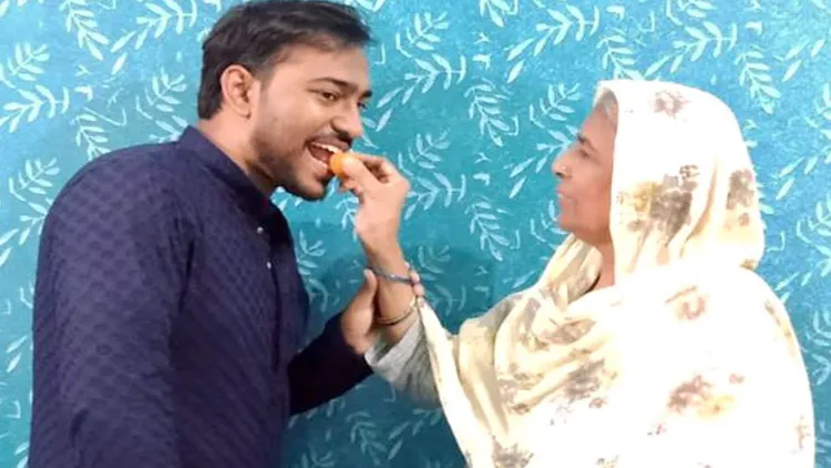 Mohibullah Ansari's grandmother feeding his sweets