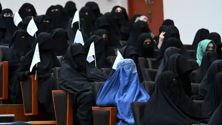 Women inside an auditorium at Kabul University’s education center