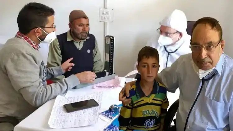 Dr Upendra Kaul with patients in Kashmir