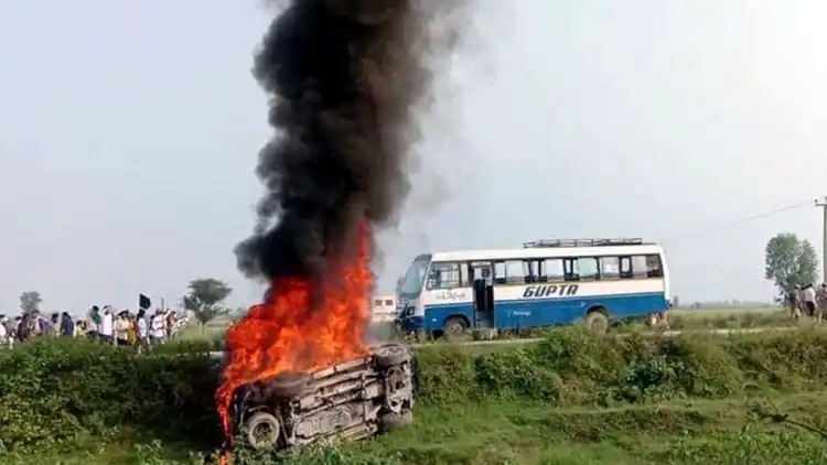 A vehicle set ablaze after violence broke out in Lakhimpur Kheri