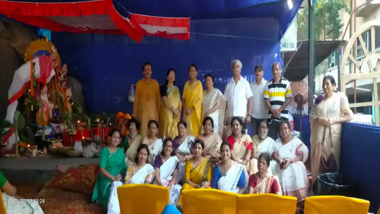 Hindu-Muslim organisers pose in front of the Puja Pandal