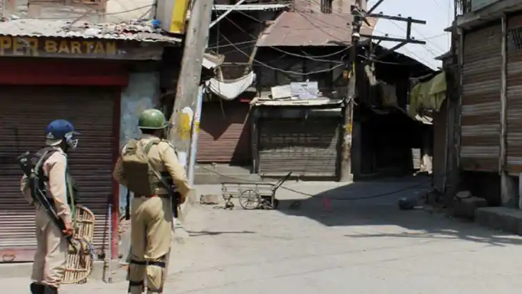 Security forces stand guard near encounter site at Rawalpora Shopian