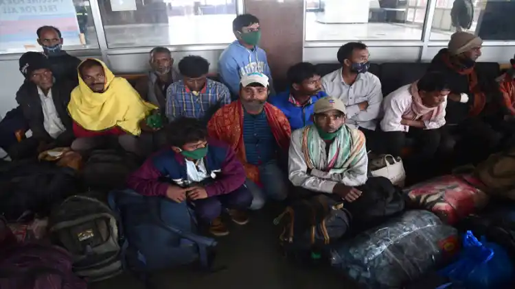 Anxious migrant labourers at Srinagar bus stand waiting to board the bus to Jammu (Pics: Basit Zargar)