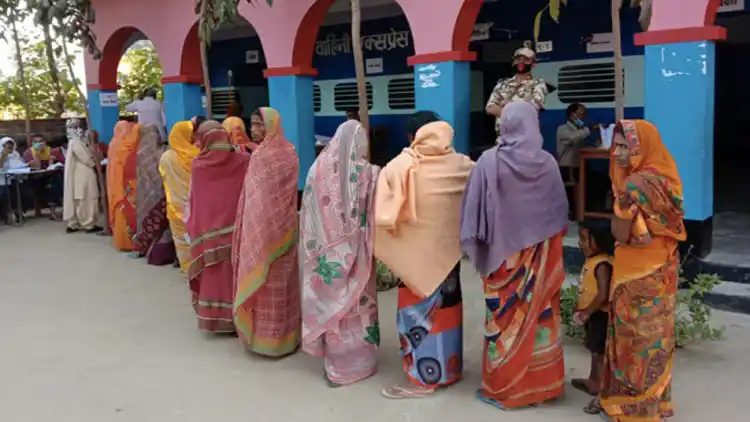 People stand in a queue at a polling station