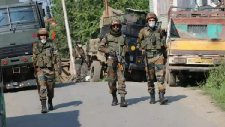 Security forces stand guard near encounter site at Rawalpora Shopian