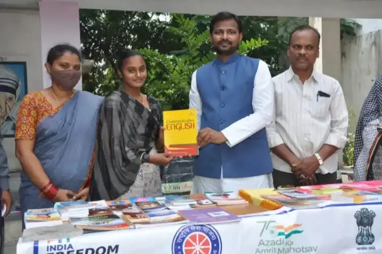 Muhammad Azim giving books to a student