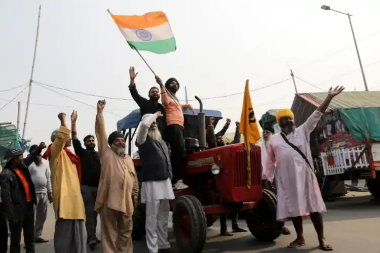 Farmers celebrate news of the repeal of farm laws
