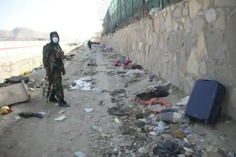 A taliban member is seen at the explosion site near the Kabul airport
