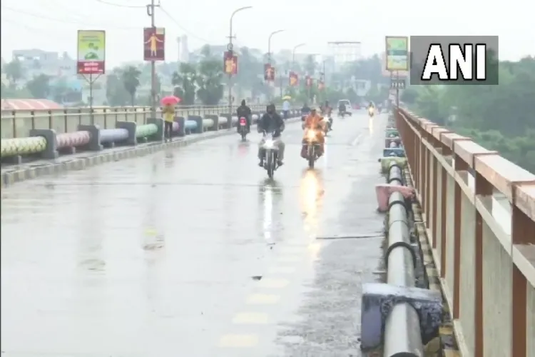 Bikers riding through the rain in Srikakulam.