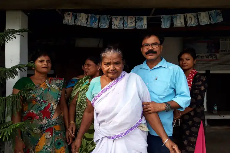 Mazibur Rahman help an old woman walk