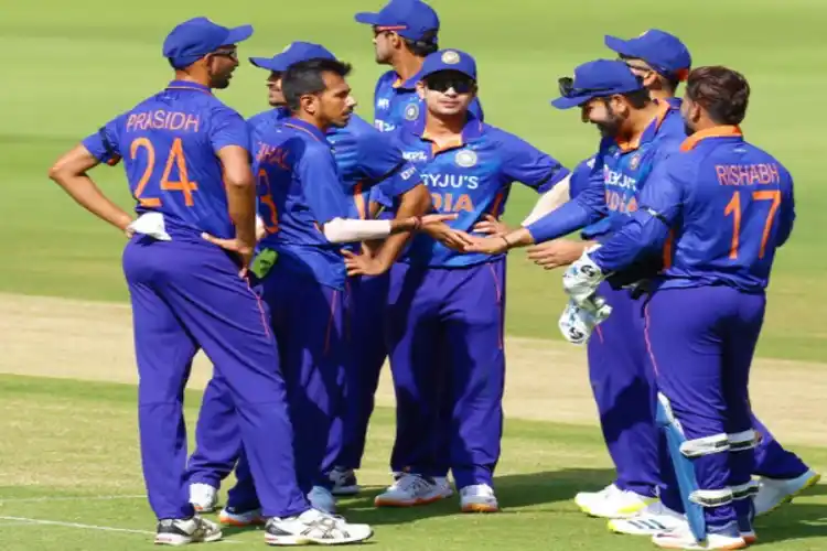 Indian cricketers celebrate the fall of a West Indian wicket.