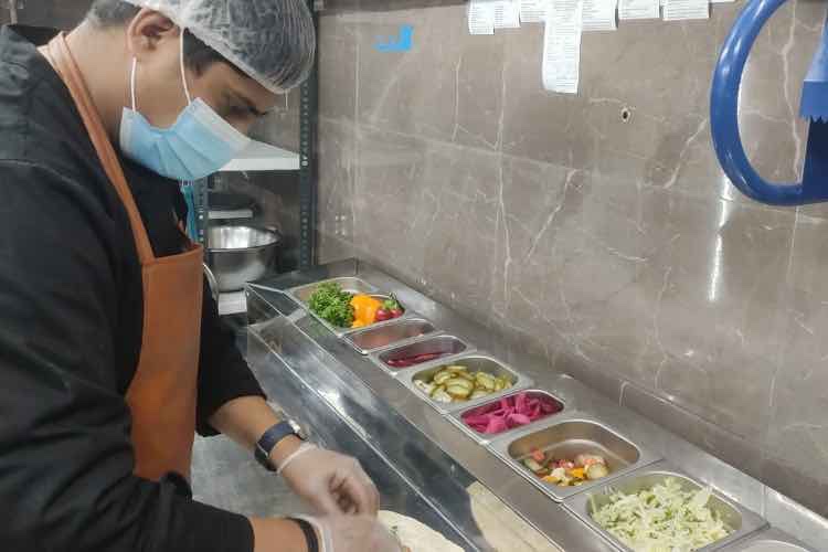 The most common layout in cloud kitchens (In frame: the chef preparing Shawarma)