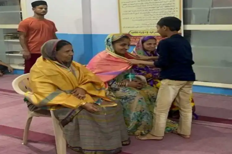 A Muslim child presenting shawl to Dayanand's daughter in-law as his wife looks on