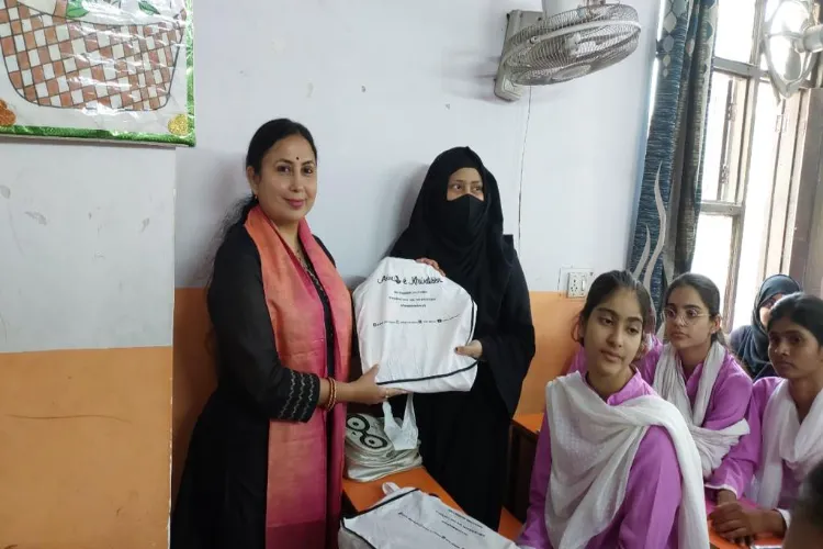 Awaz-e-Khawateen director Ratna Shukla Anand distributing suits and bags to girls in Okhala