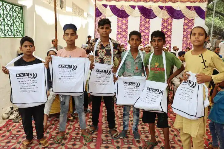 Children displaying their gift received from Awaz-the Voice