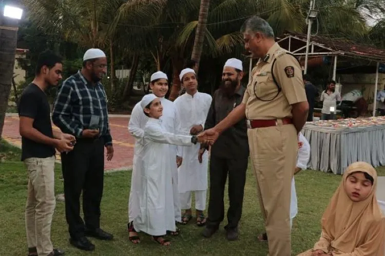 Police Commissioner Harish Baijal shaking hands with a guest at the Iftar Party
