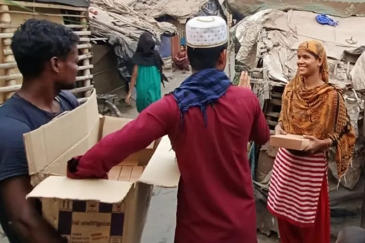 The Human Welfare Society volunteers distributing food packets