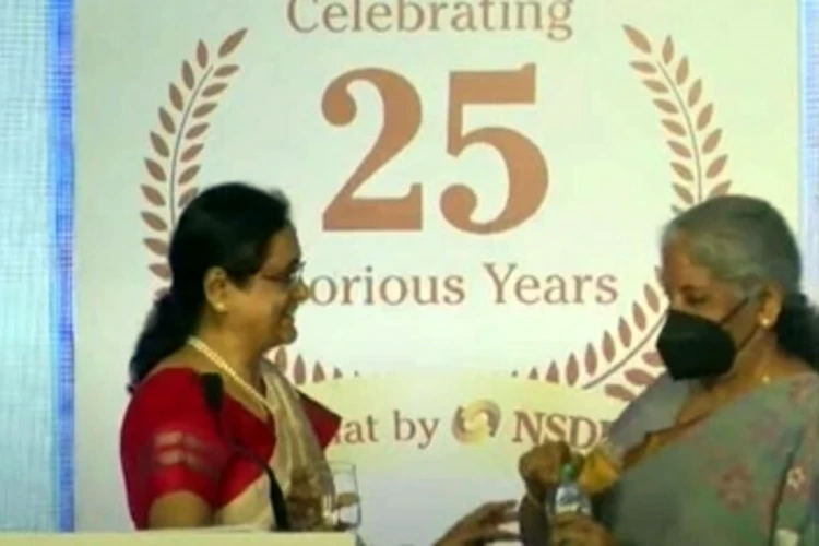 Nirmala Sitharaman offering water to NSDL MD Padmaja Chunduru