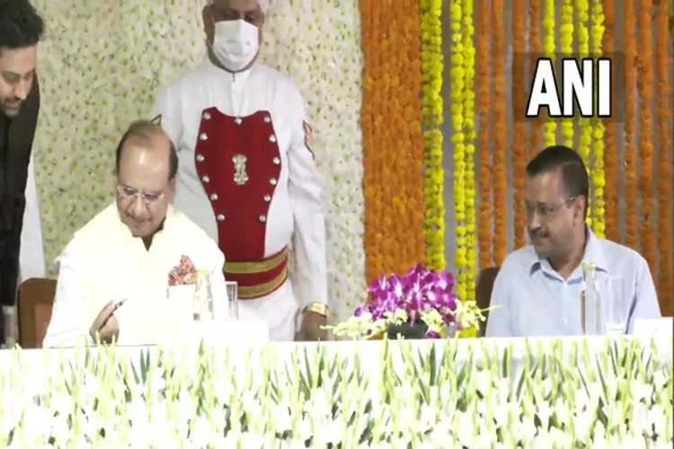 Vinai Kumar Saxena takings oath as Delhi LG in presence of Arvind Kejriwal