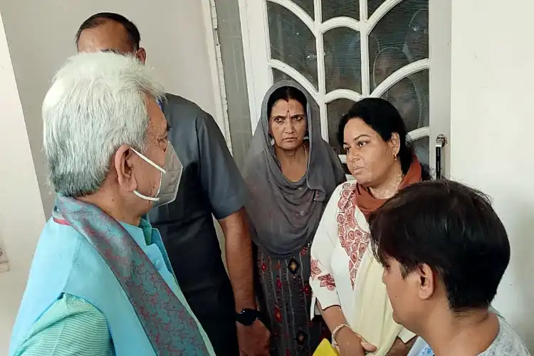 Lt Governor Manoj Sinha meeting the family members of slain teacher 