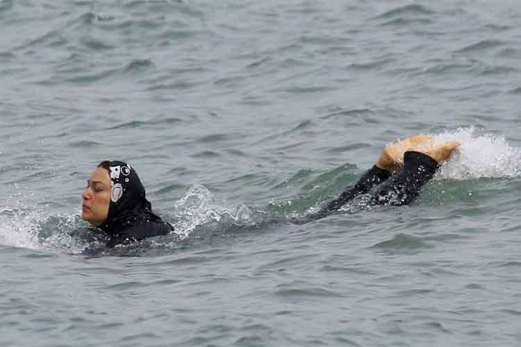 A woman swimming in burkini