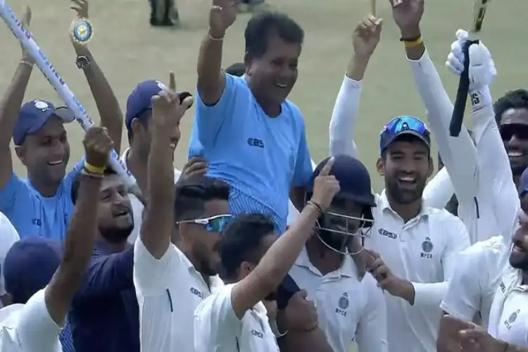 Players of Madhya Pradesh team celebrating with their coach