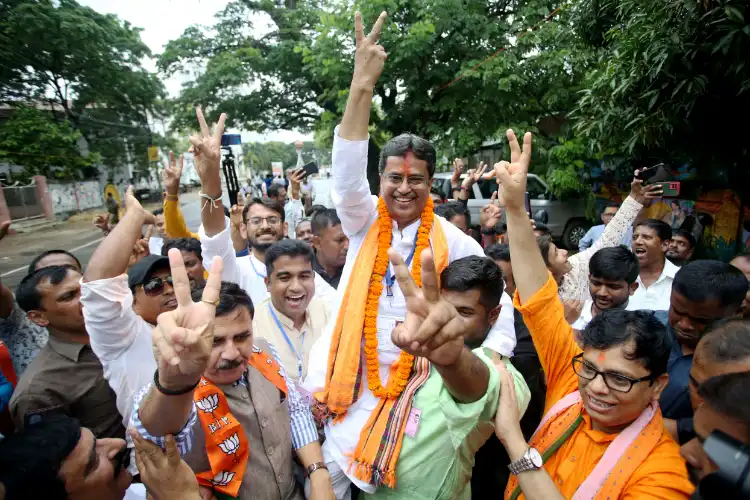 Manik Saha being taken in a procession by his supporters after his victory