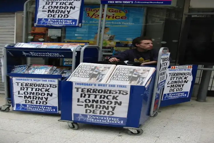 A vendor selling newspapers with report of deadly terror attack in London