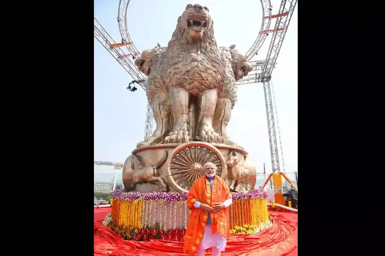 PM Narendra Modi with the National Emblem atop the new Parliament Building