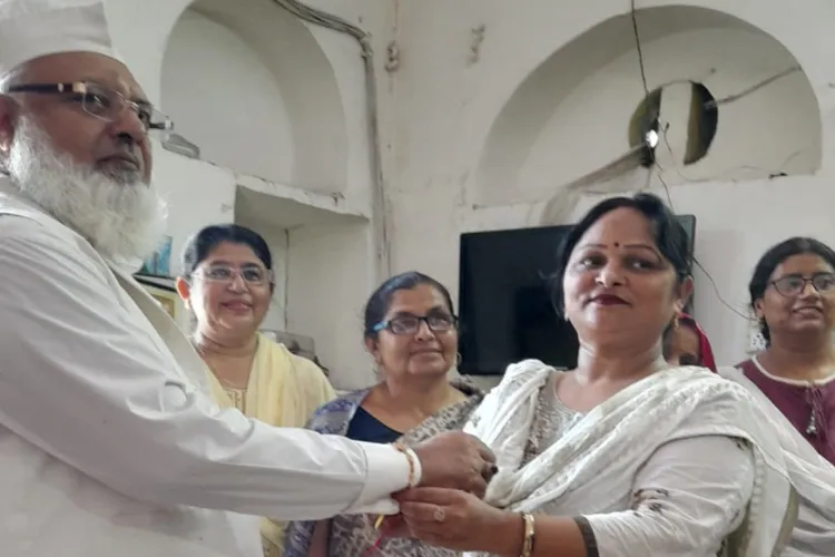 Pushpa Yadav tying Rakhi to Haji Jameeluddin Qureshi