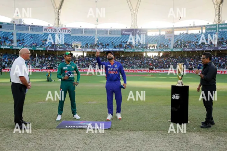 India's Rohit Sharma flips the coin at Dubai International Cricket Stadium